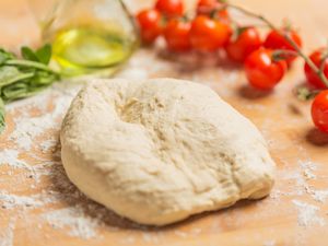 Pizza dough on a wooden board