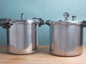 Best pressure canners displayed on a wooden surface in front of a blue wall