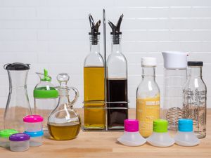 A variety of salad dressing containers displayed on wood counter