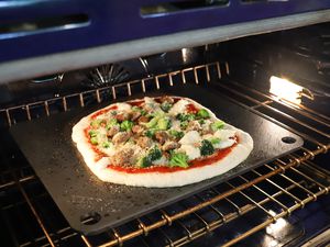 A pizza on NerdChef Steel Stone in an oven