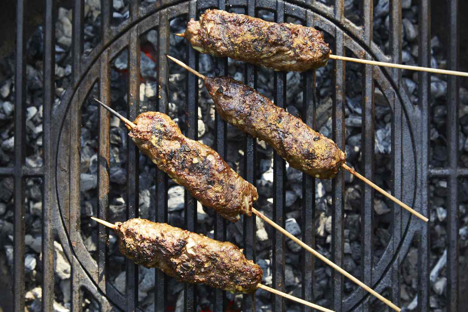 Adana Kebab (Ground Lamb Kebab) cooking on a grill 