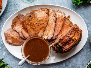 Au jus in a bowl and drizzled over beef