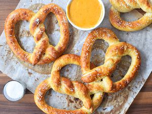 Copycat Auntie Anne's pretzels on wax paper with mustard and salt