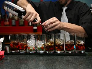 Barman building cocktails in the bar