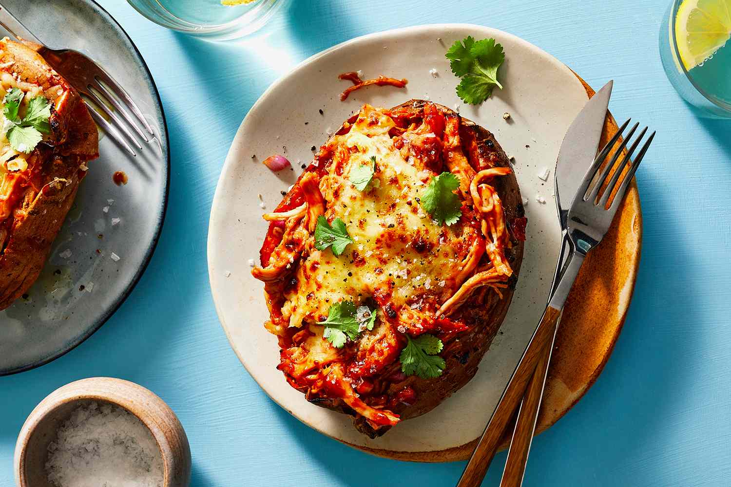 BBQ Chicken Stuffed Sweet Potato on a plate with a knife and fork 