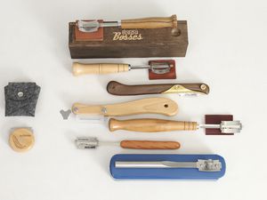 Several bread lames displayed on a white surface