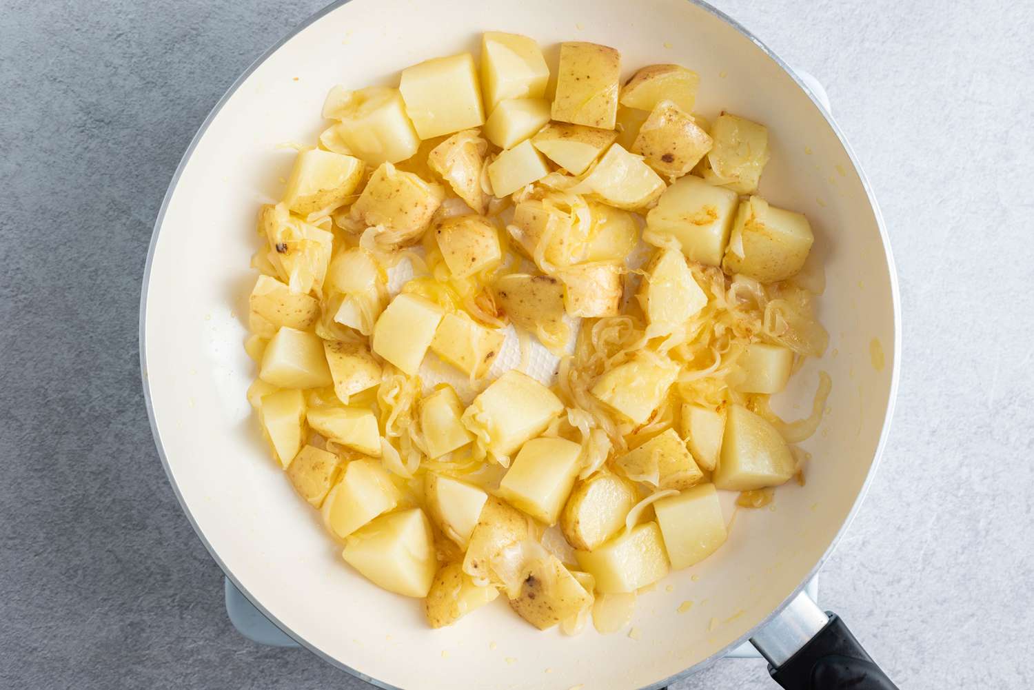 potatoes and onions in a large skillet