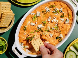 A close-up of a casserole dish filled with delicious-looking chicken dip.