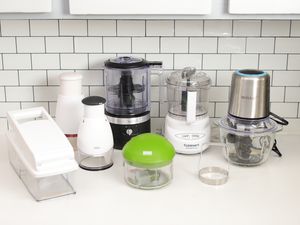 Eight of the Best Food Choppers arranged on a white kitchen counter with tile in the background 