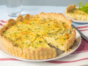 Cheese and onion flan on a white plate