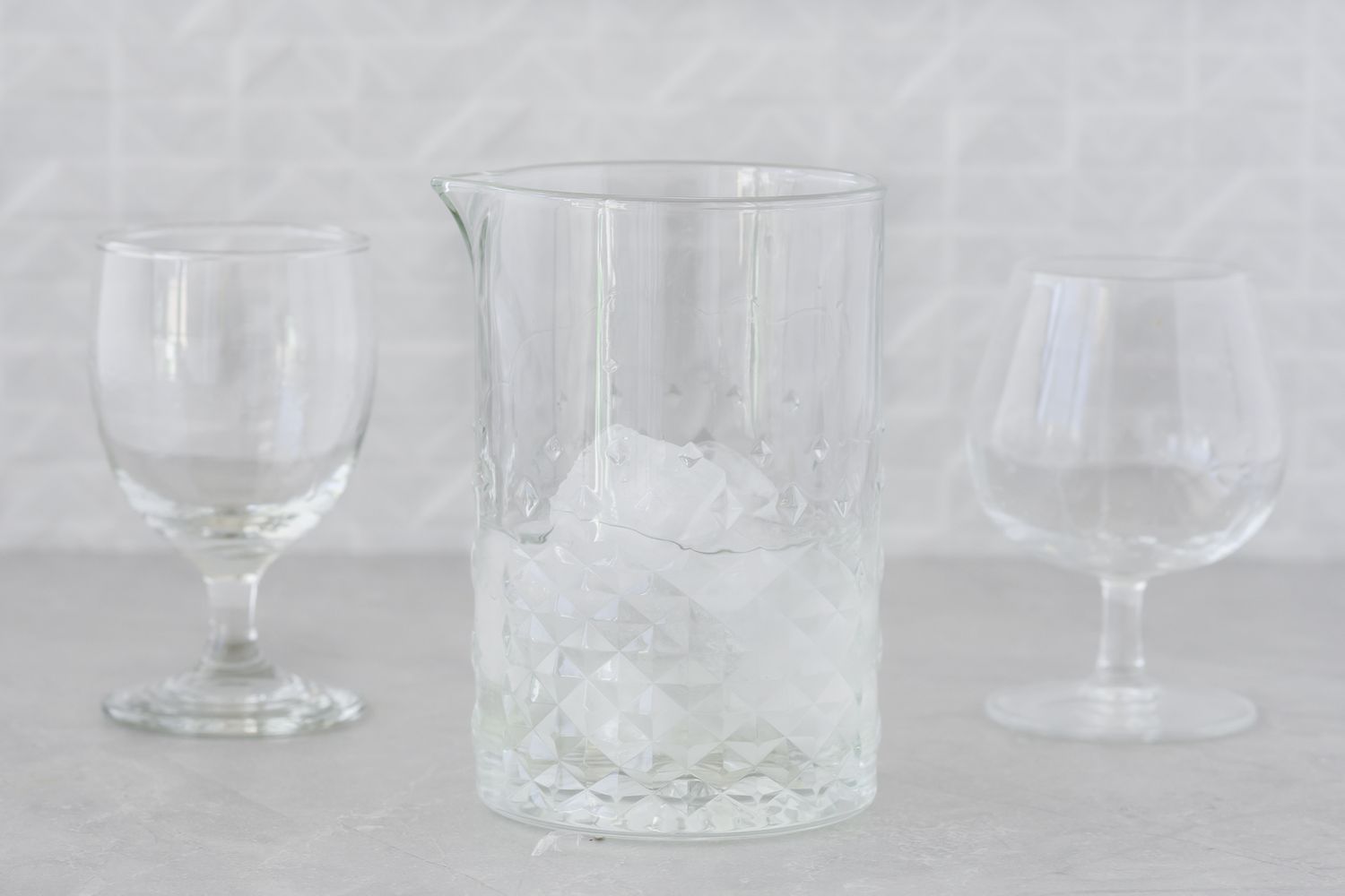 Gin and vermouth combined in a mixing glass with ice