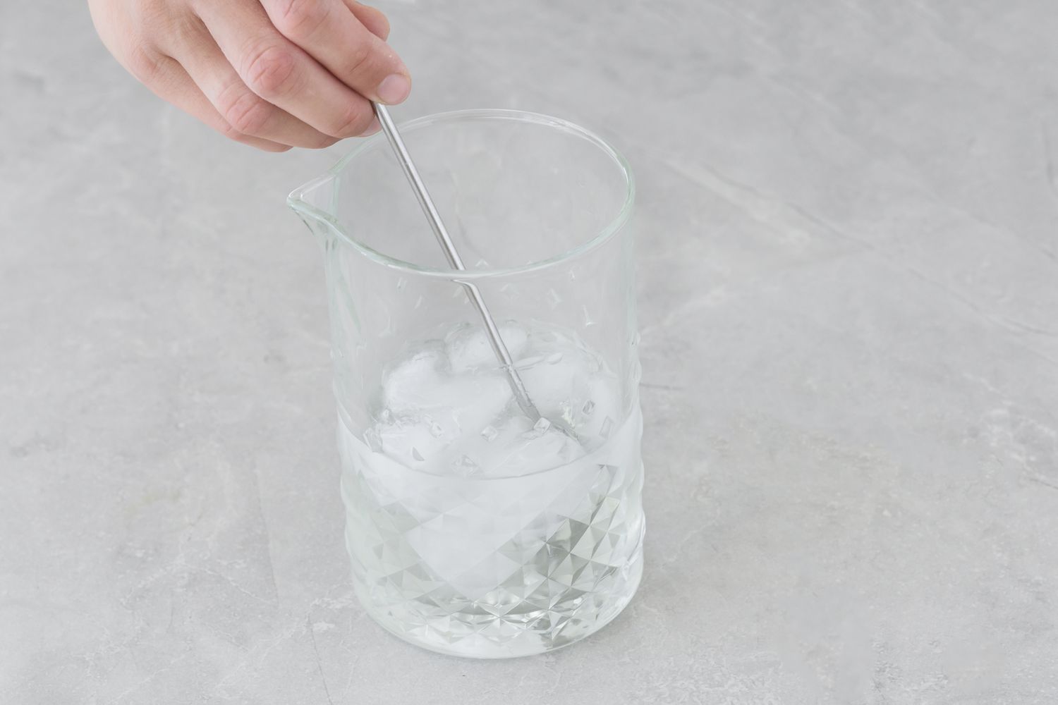 Gin martini ingredients being stirred in the mixing glass