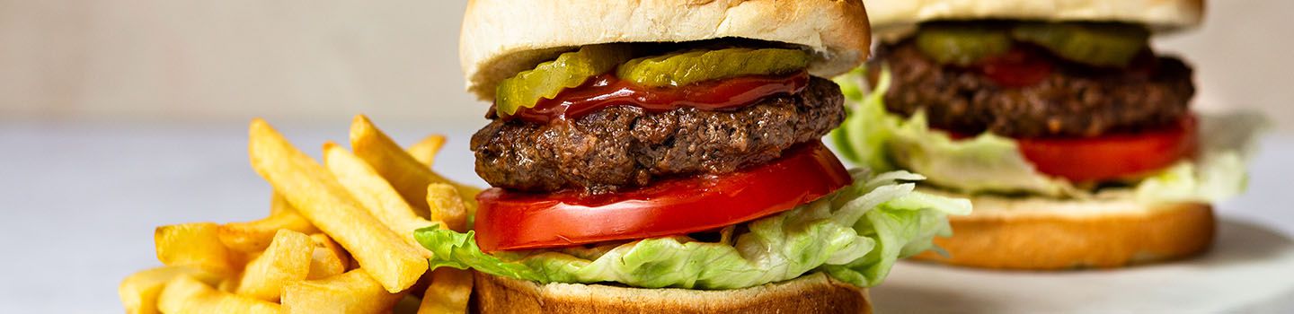 Two Slow Cooker Hamburgers on Buns With a Side of Fries