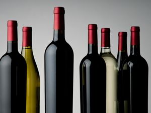 Close-Up Of Wine Bottles Over White Background