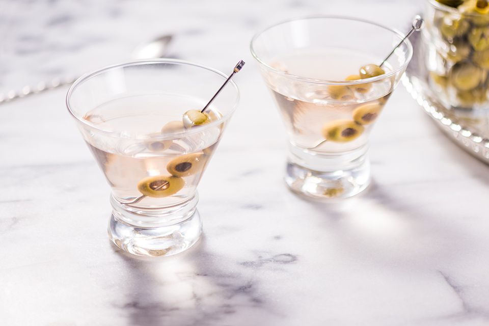 Classic gin martini garnished with olives on toothpicks