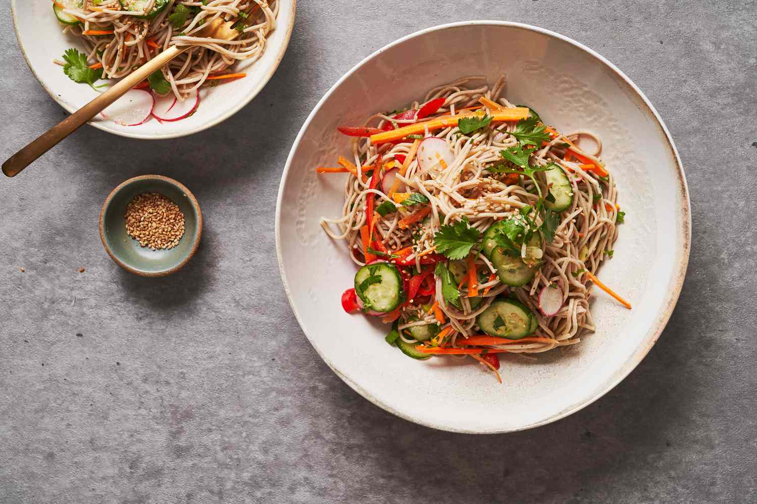 Two bowls of cold soba noddle dishes 