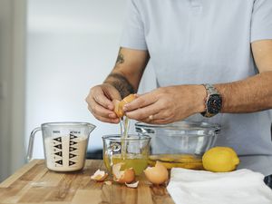 Man cracking an egg into a bowl