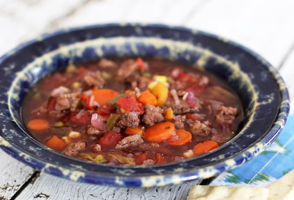 A blue and white bowl of crock pot hamburger soup