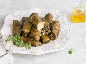 Stuffed grape leaves resting on a plate