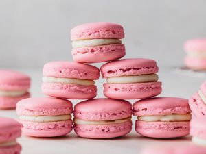 Pink macarons with buttercream filling stacked up