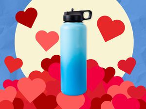 A blue water bottle sitting on a mountain of hearts.