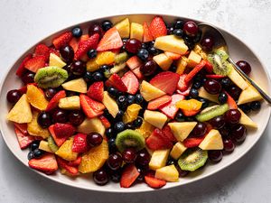 Easy Fruit Salad on a platter with a serving spoon 