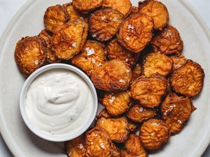 Fried Pickles on a platter with sauce 