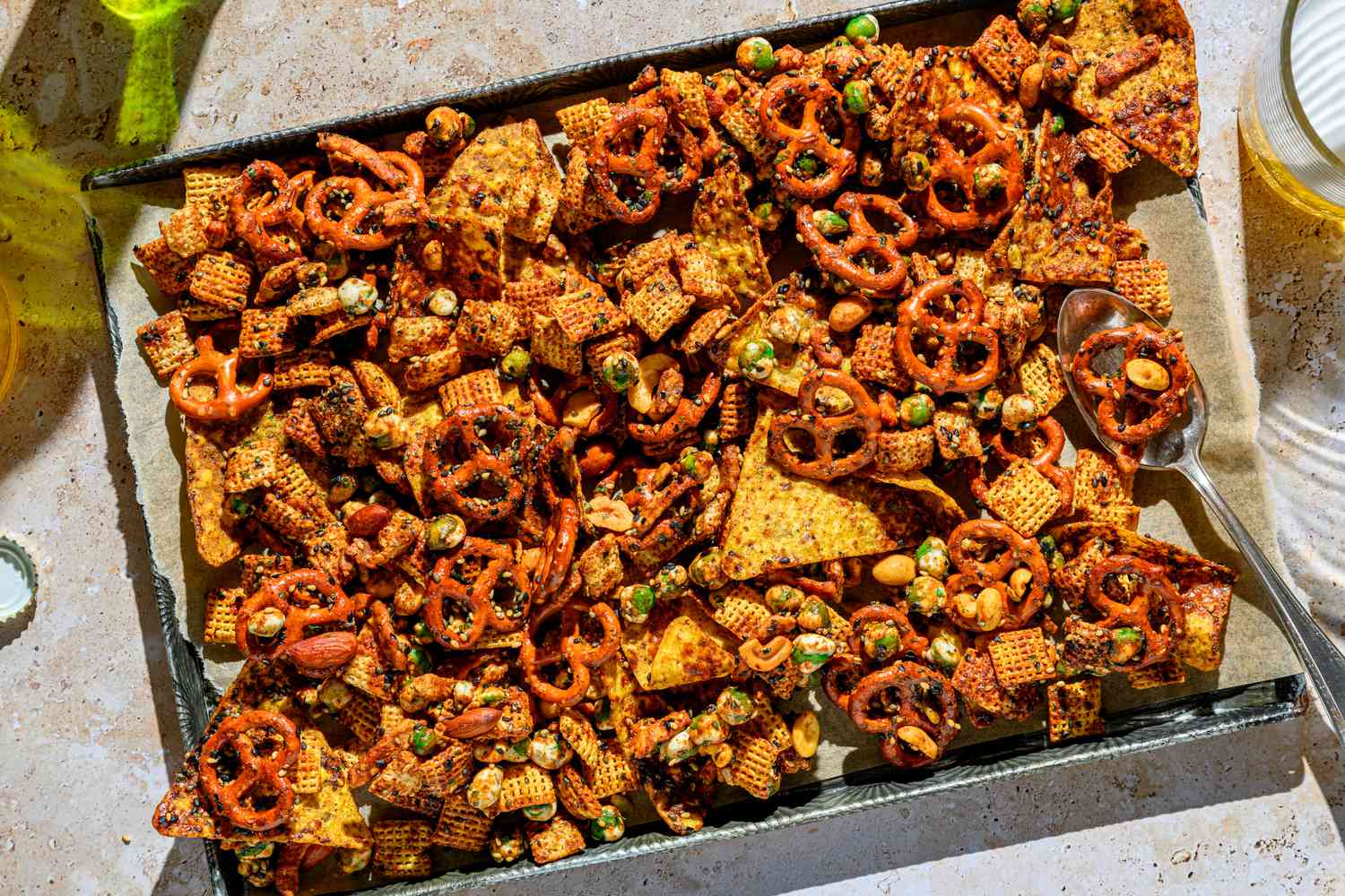 A baking sheet of furikake chex mix, served with beer