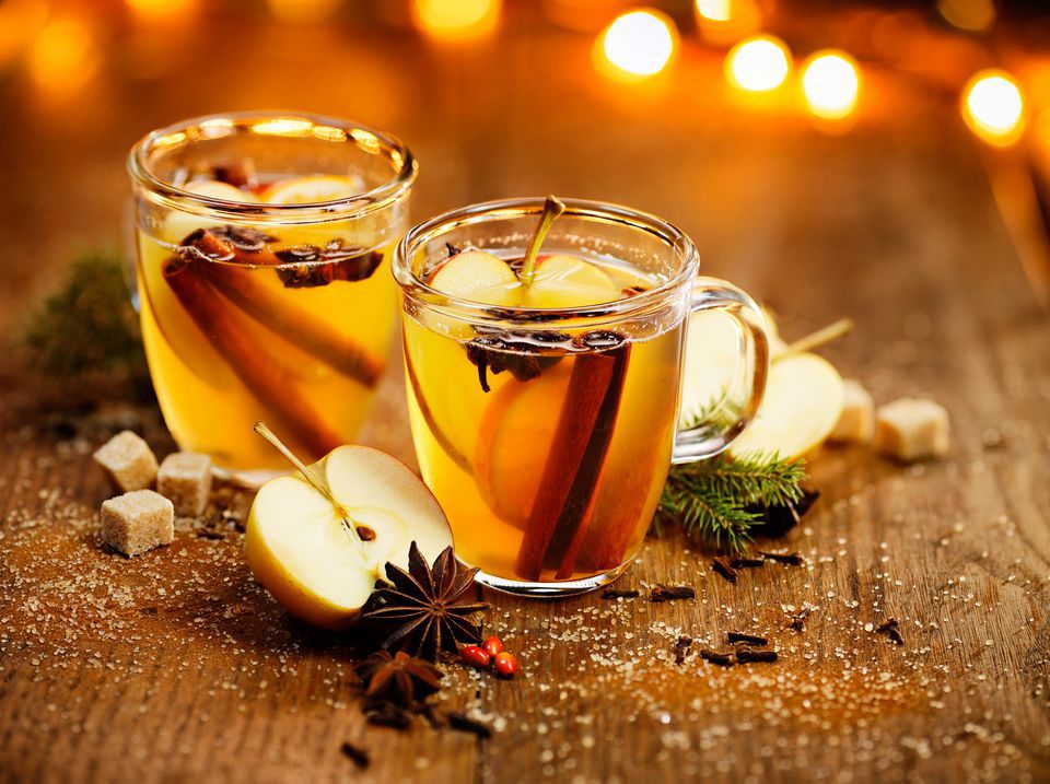 Two glass coffee mugs with hot gold apple cider