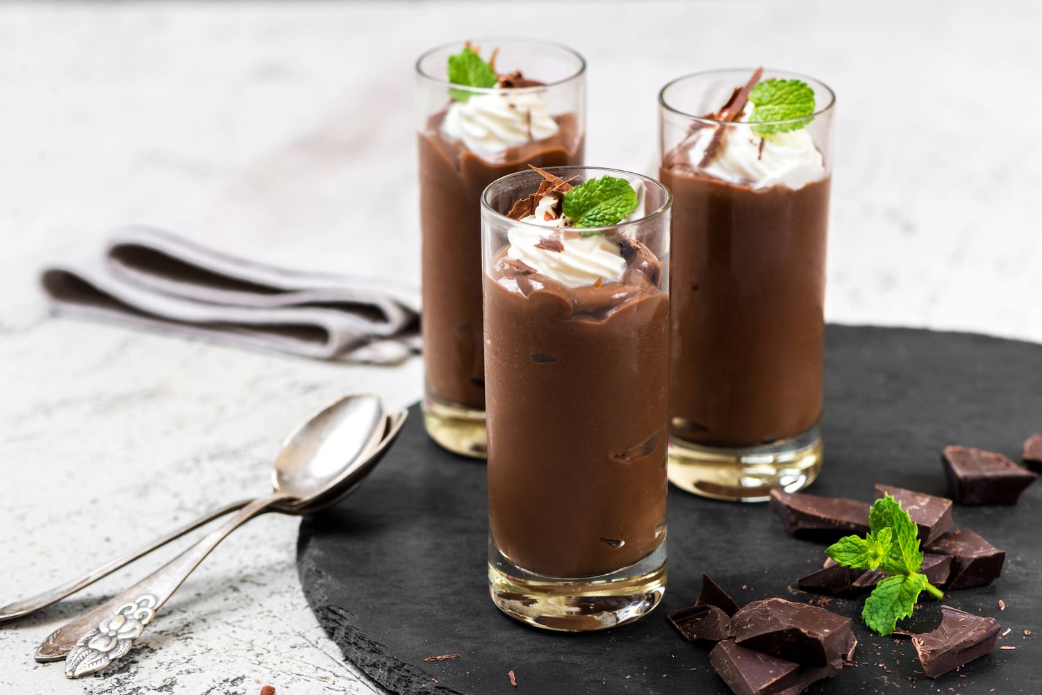 Chocolate pudding shots with whipped cream and mint