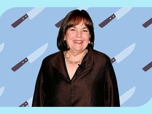 A photo of Ina Garten in front of a repeating pattern of illustrated kitchen knives