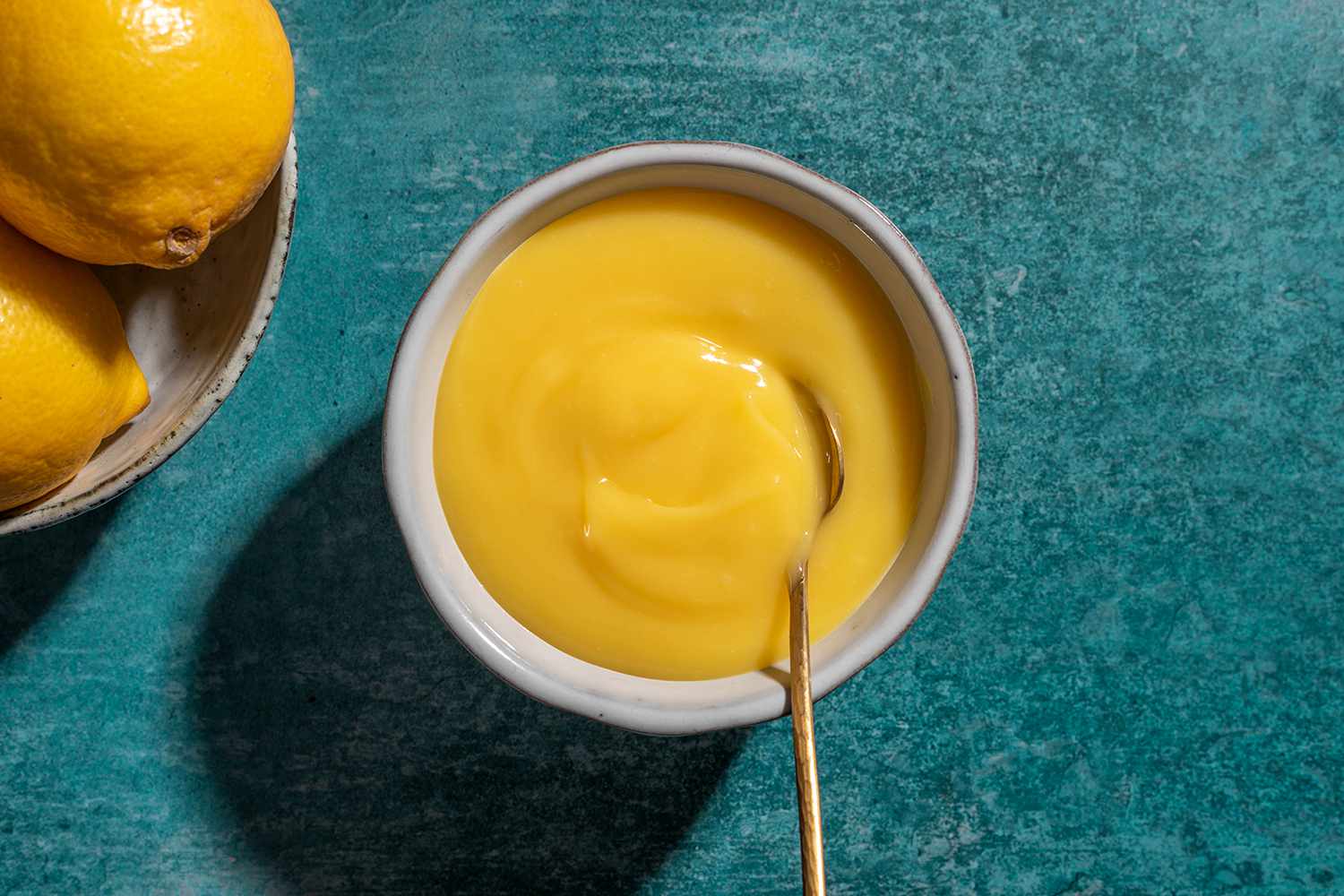 Instant Pot Lemon Curd in a bowl with a spoon 