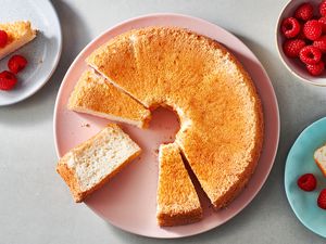 Keto Angel Food Cake on a platter and on plates, served with berries 