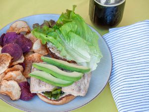 mahi-mahi burger with avocado, roasted poblano and cumin mayo