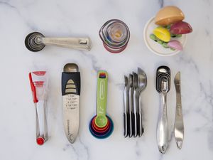 Assortment of measuring spoons we recommend displayed on a marble surface