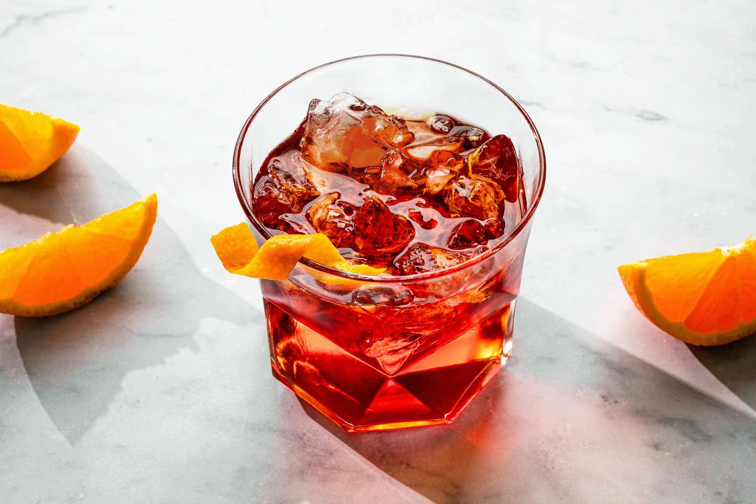 Negroni cocktail recipe in a glass with an orange twist