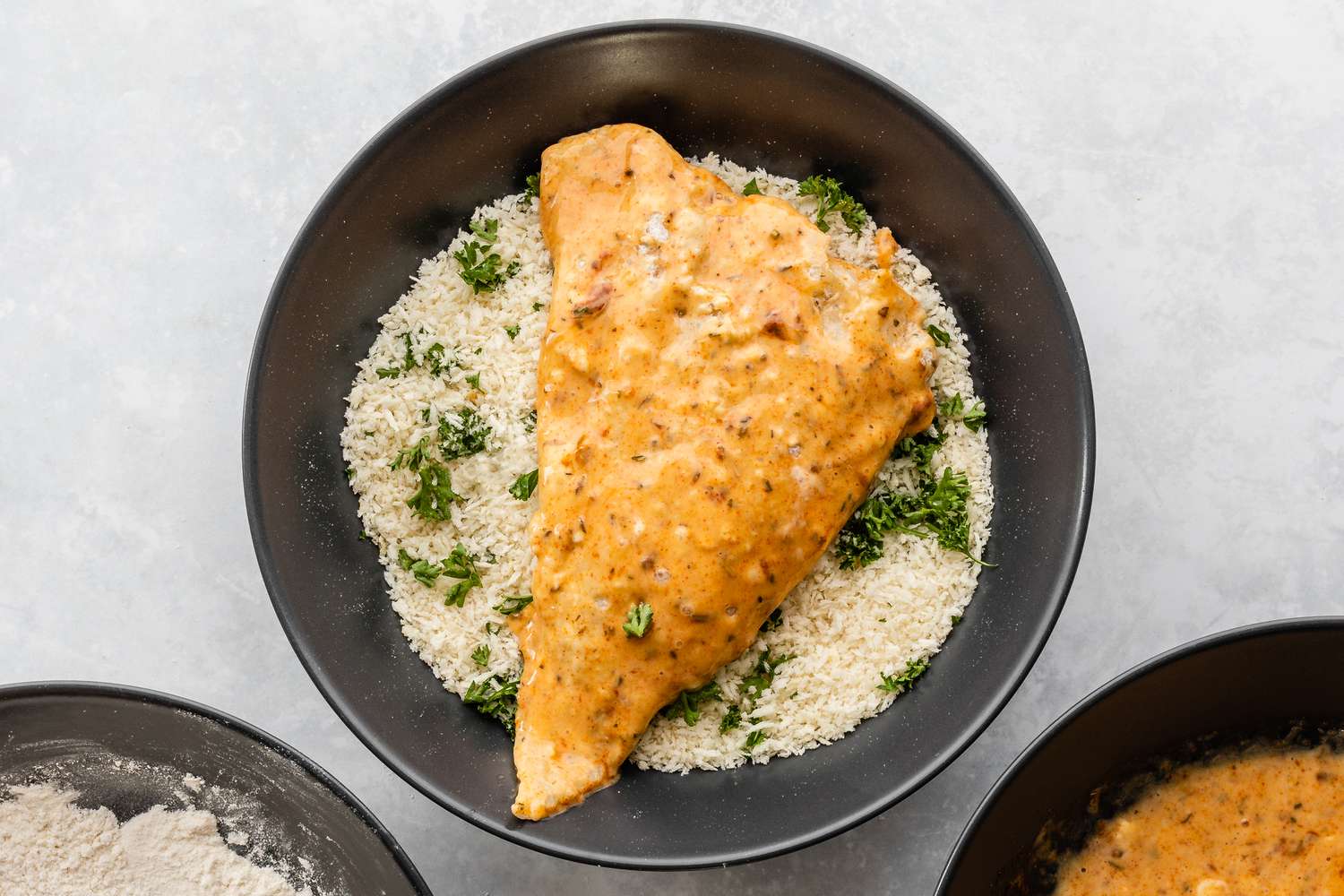 Haddock fillets in a bowl with panko and parsley