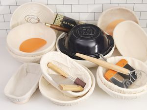 Several proofing baskets displayed on a white counter