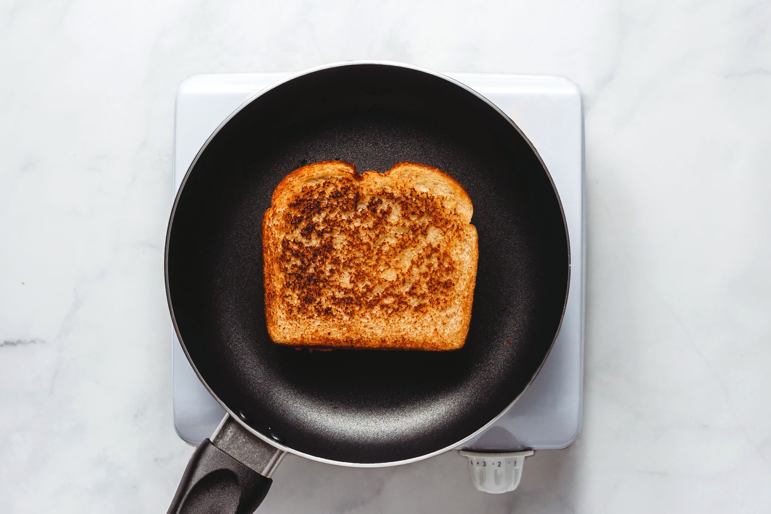 grilled cheese browned on one side in pan