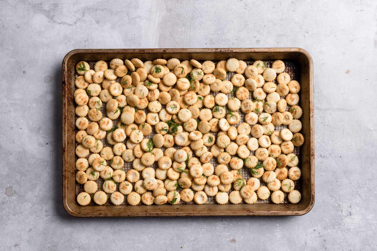 Seasoned oyster crackers on a baking sheet