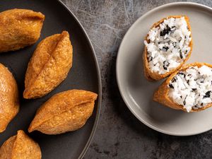 Rice Stuffed Tofu Pockets (Inari Sushi) on two plates