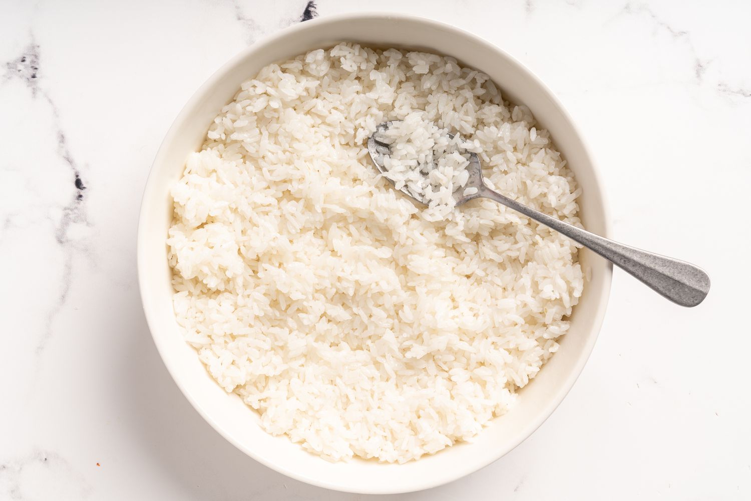 Cooked rice resting in a white bowl