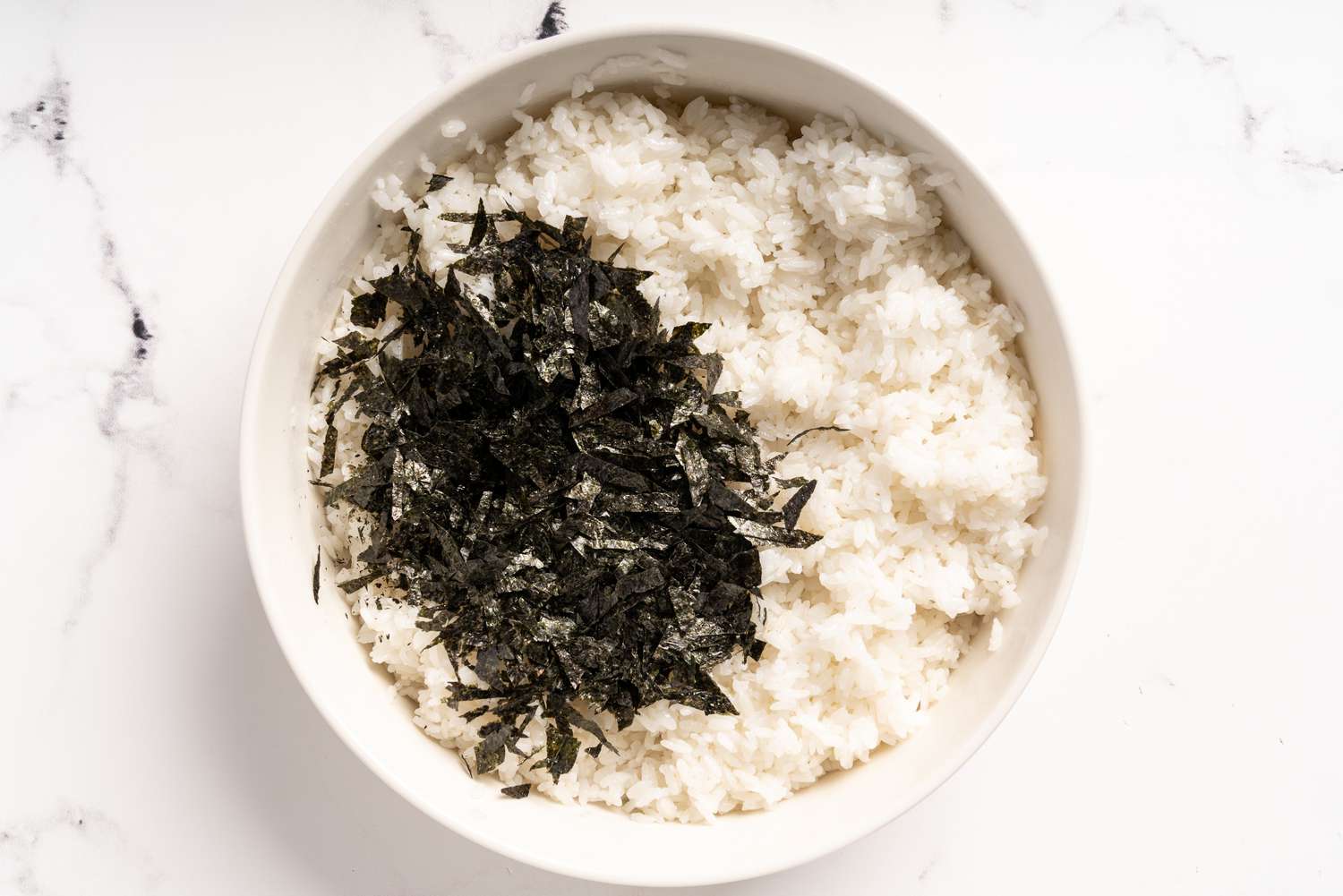 Seaweed being mixed into the seasoned rice