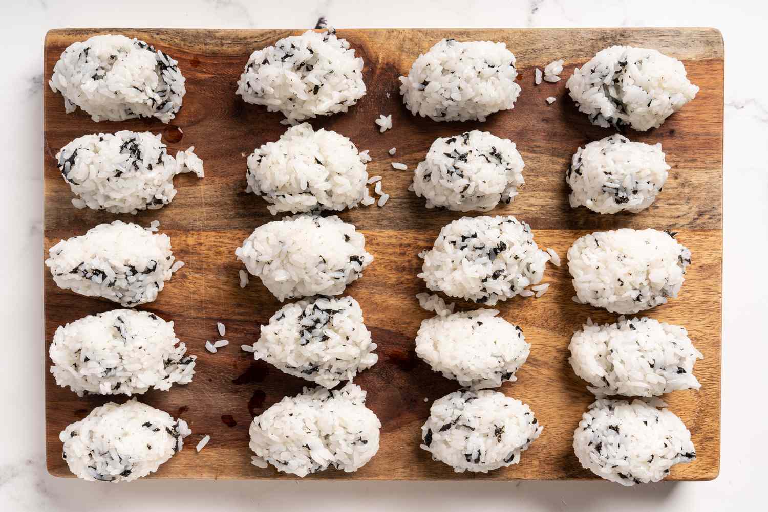 Rice and seaweed in zeppelin-shaped balls on a wood board 