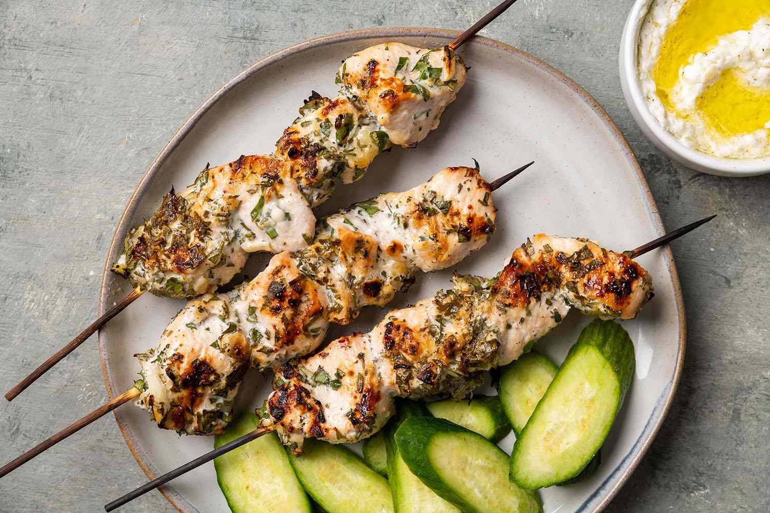 Romanian Chicken Kebabs (Frigarui) on a plate with cucumber slices 