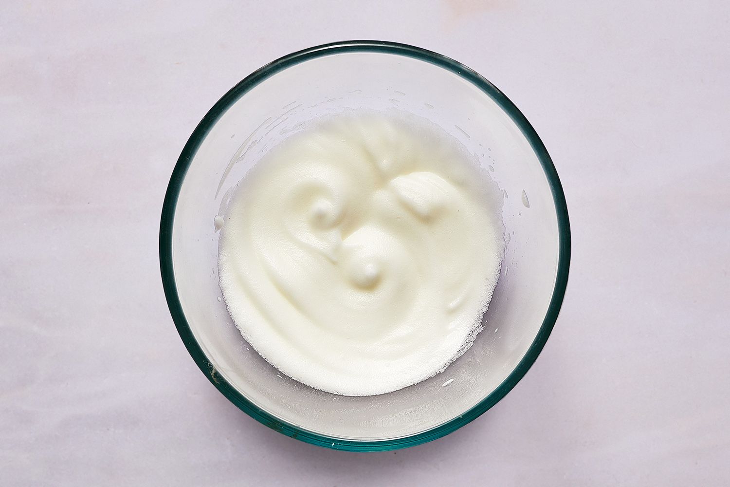 whipped egg whites in glass bowl