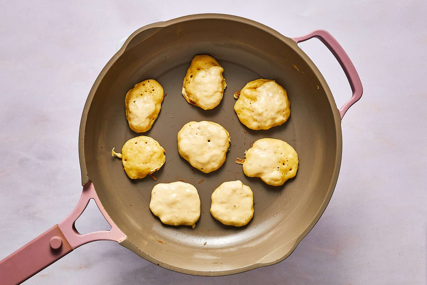 blini cooking in fry pan