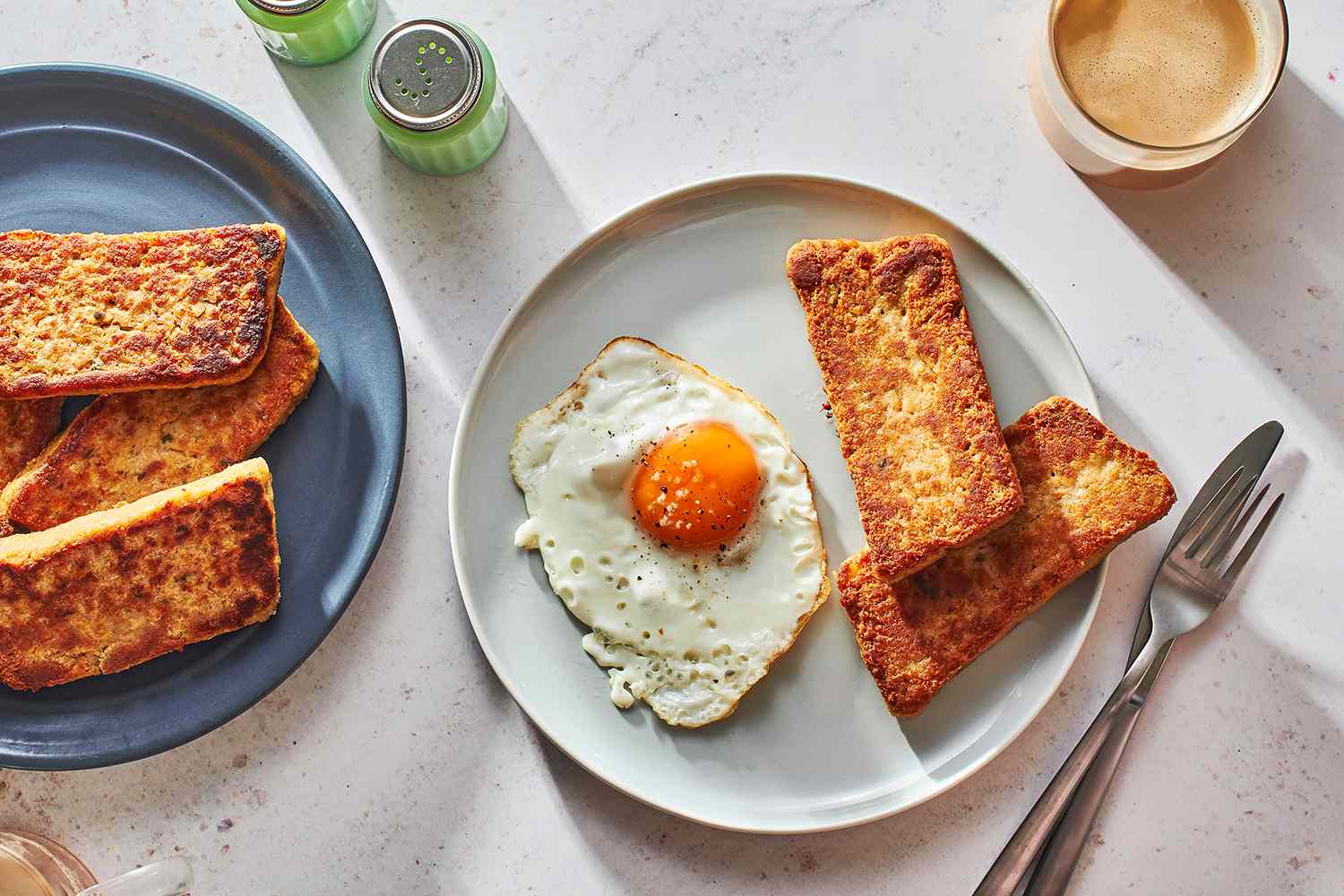 fried scrapple served with sunny side up eggs on a plate