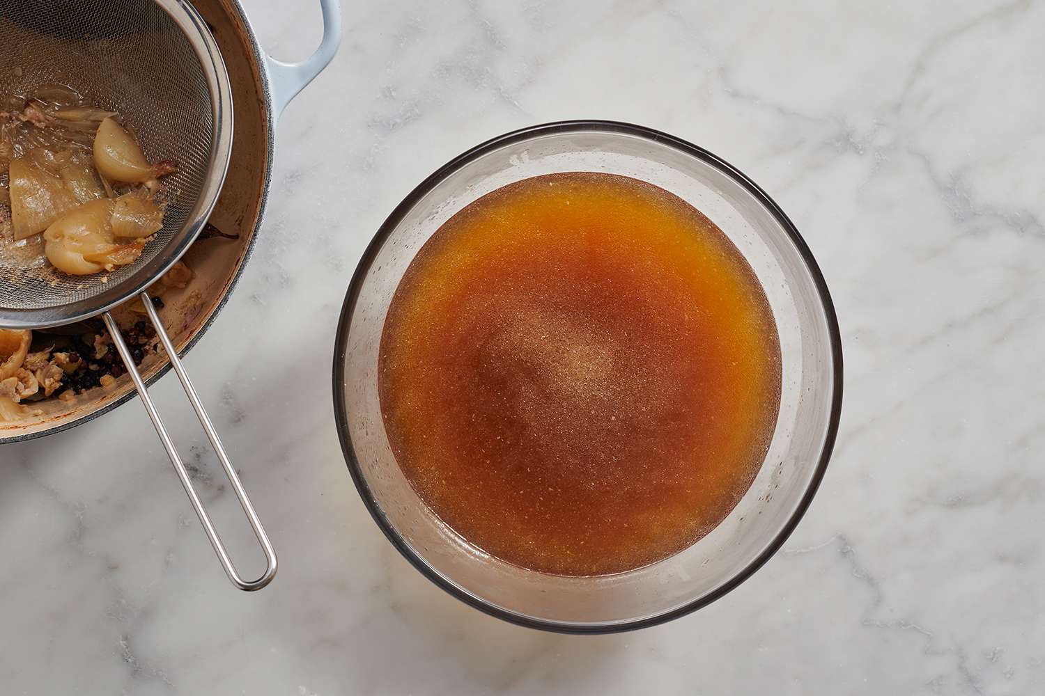 strained pork broth in a bowl