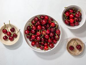 Various bowls filled with red cherries